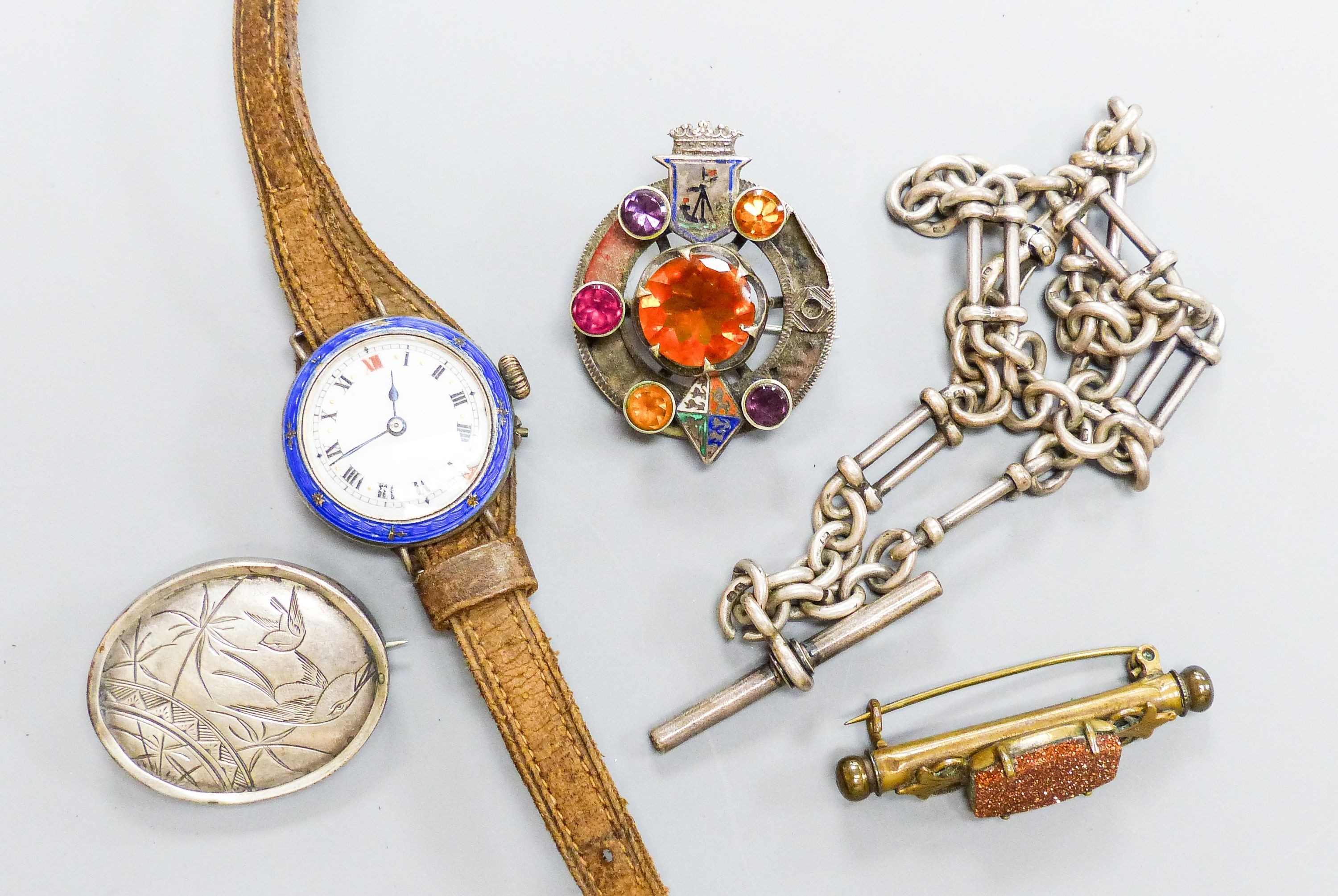 A white metal, paste and enamel set brooch, 40mm, a silver albert, two brooches and a lady's white metal and enamel wrist watch.